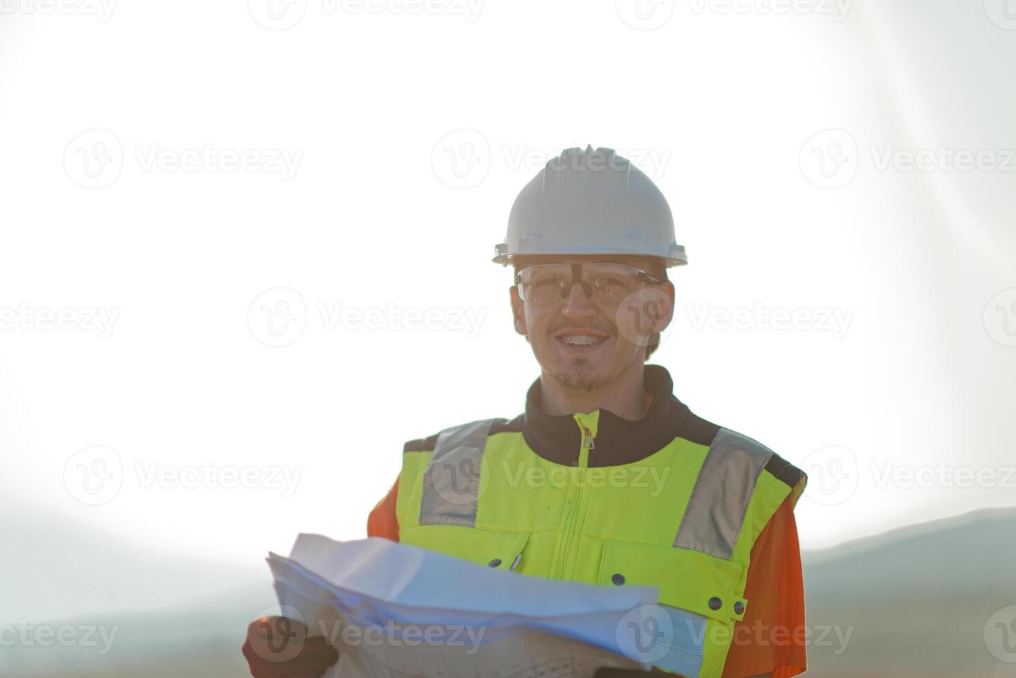 An engineer holding a paper project of a wind turbine for electricity production. photo