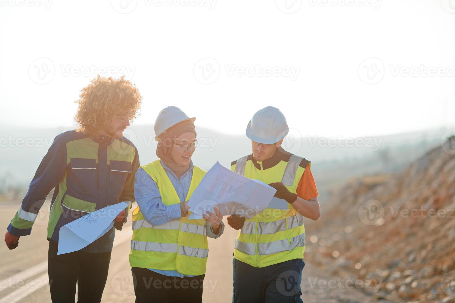 A team of engineers and workers oversees a wind turbine project at a modern wind farm, working together to ensure the efficient generation of renewable energy photo