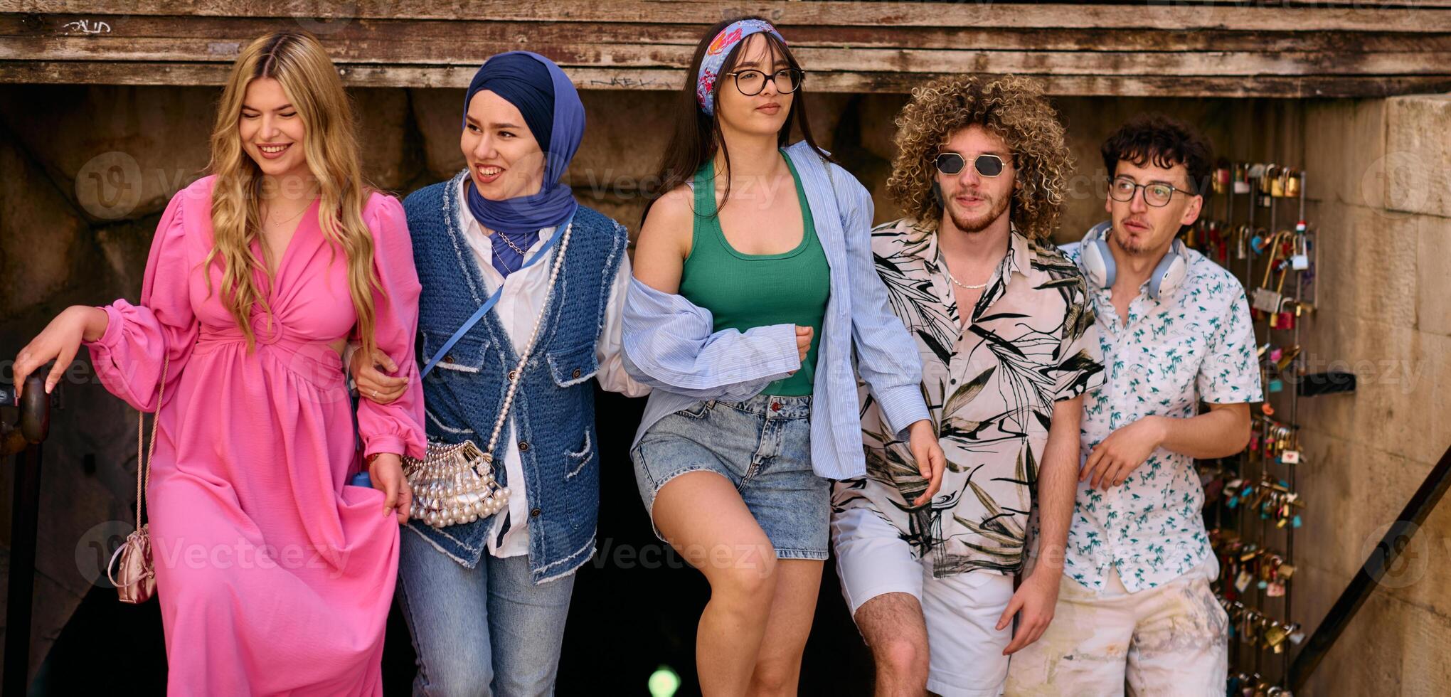 A diverse group of tourists, dressed in summer attire, strolls through the tourist city with wide smiles, enjoying their sightseeing adventure photo