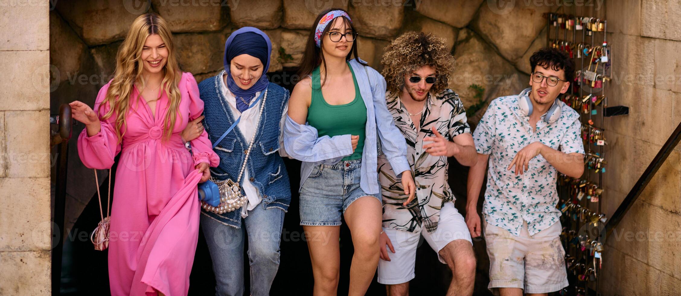 A diverse group of tourists, dressed in summer attire, strolls through the tourist city with wide smiles, enjoying their sightseeing adventure photo
