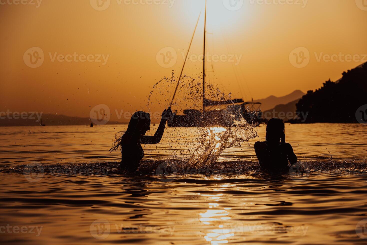 Group of female friends have a playful moment in the sea during sunset, their hair dancing in the wind, capturing their joyful bonding and carefree spirit by the beach photo