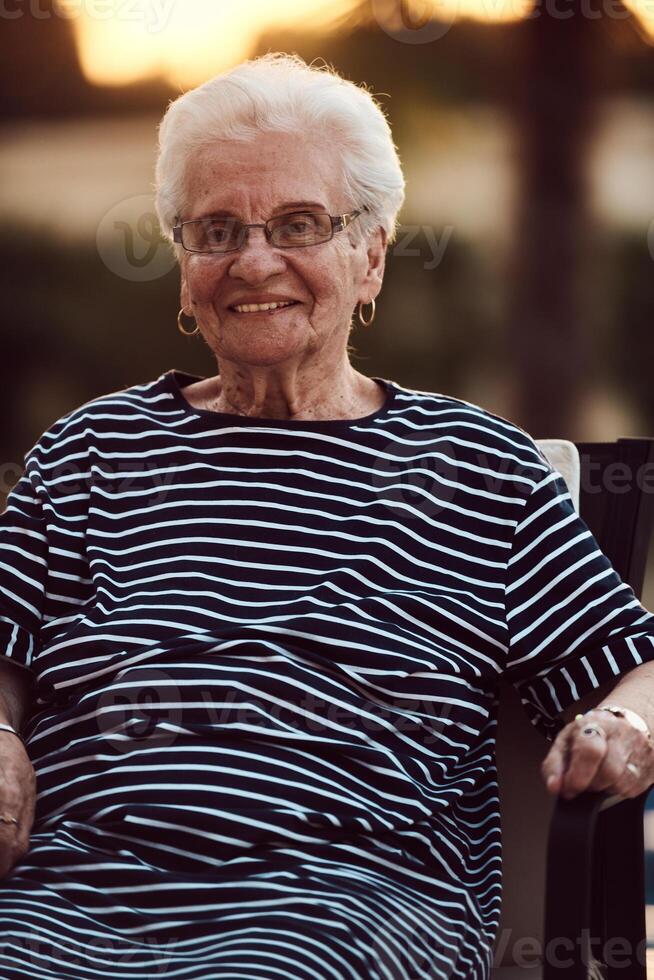 Unfiltered portrait, a real elderly woman sits gracefully in a chair, showcasing the authenticity of aging with wrinkles and a natural face photo