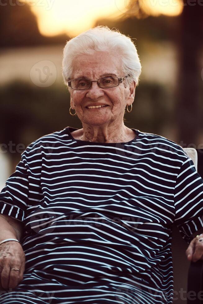 Unfiltered portrait, a real elderly woman sits gracefully in a chair, showcasing the authenticity of aging with wrinkles and a natural face photo