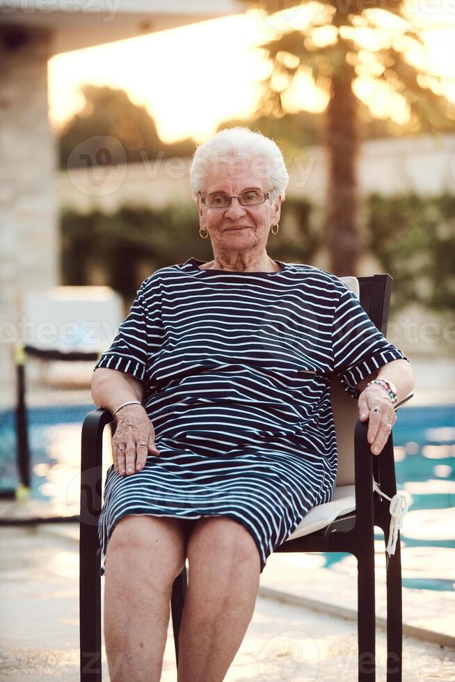 Unfiltered portrait, a real elderly woman sits gracefully in a chair, showcasing the authenticity of aging with wrinkles and a natural face photo