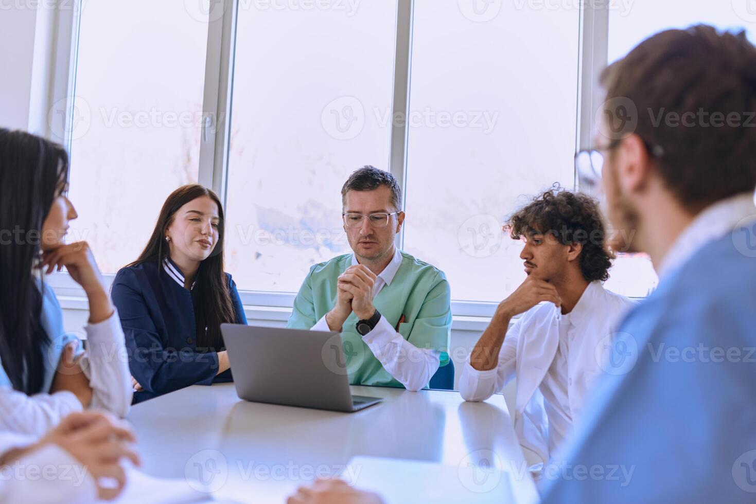 A dedicated group of doctors and medical nurses attentively listens to their colleague's work plan in a healthcare facility, fostering collaboration and ensuring high-quality patient care photo