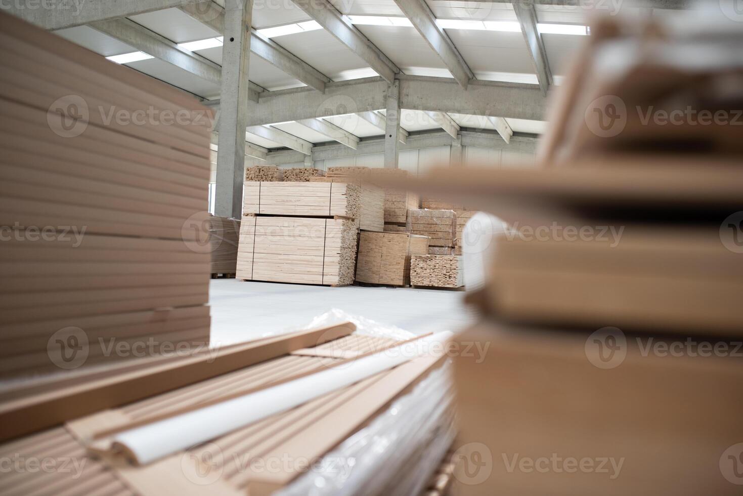 A vast warehouse in the forestry industry, showcasing a plethora of wooden products, including boards and various timber items neatly organized in storage photo
