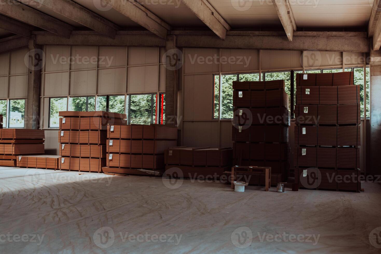 A vast warehouse in the forestry industry, showcasing a plethora of wooden products, including boards and various timber items neatly organized in storage photo