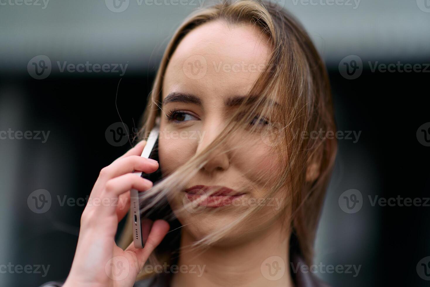Business Woman With Phone Near Office. Portrait Of Beautiful Smiling Female In Fashion Office Clothes Talking On Phone While Standing Outdoors. Phone Communication. photo