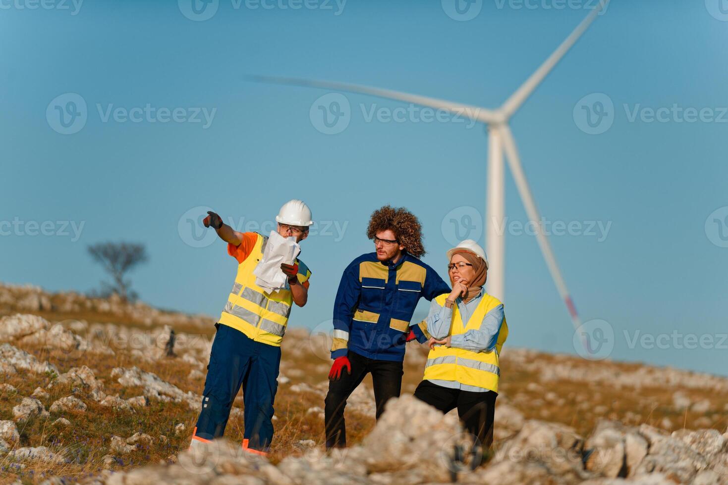 A team of engineers and workers oversees a wind turbine project at a modern wind farm, working together to ensure the efficient generation of renewable energy photo