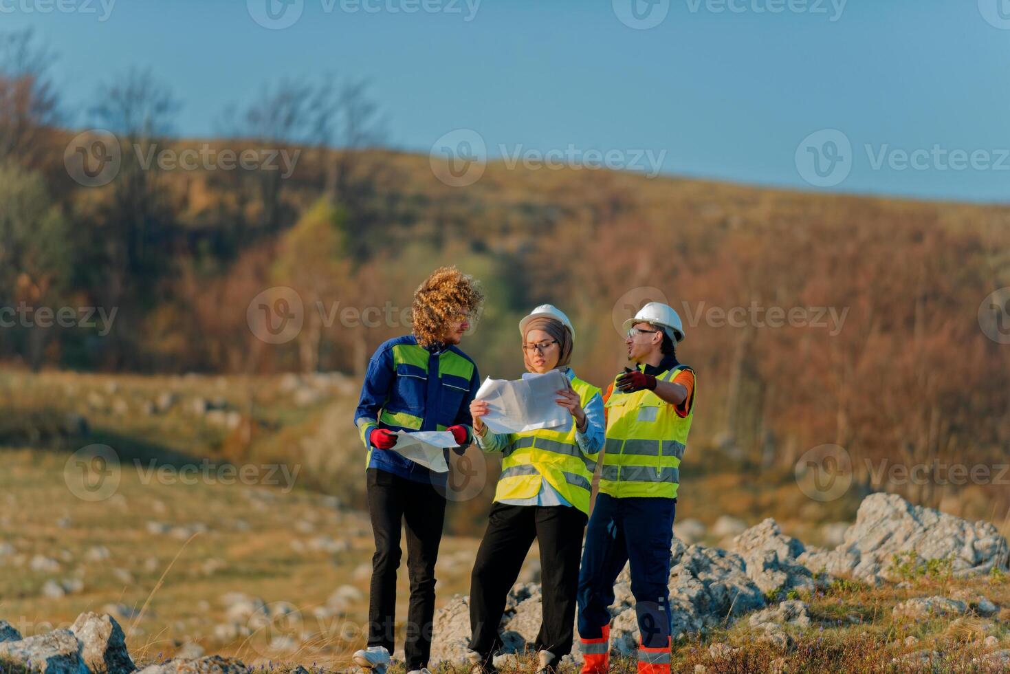 A team of engineers and workers oversees a wind turbine project at a modern wind farm, working together to ensure the efficient generation of renewable energy photo