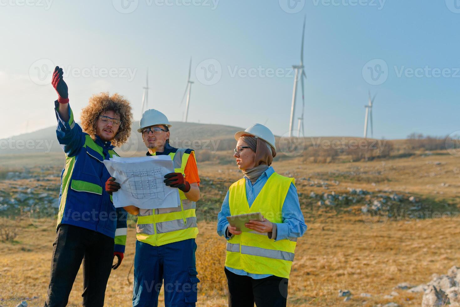 A team of engineers and workers oversees a wind turbine project at a modern wind farm, working together to ensure the efficient generation of renewable energy photo