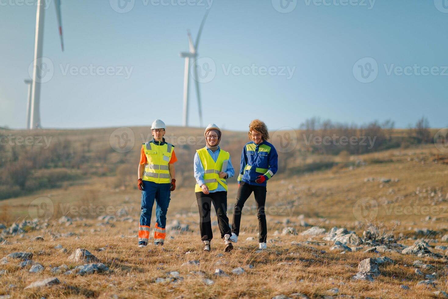A team of engineers and workers oversees a wind turbine project at a modern wind farm, working together to ensure the efficient generation of renewable energy photo