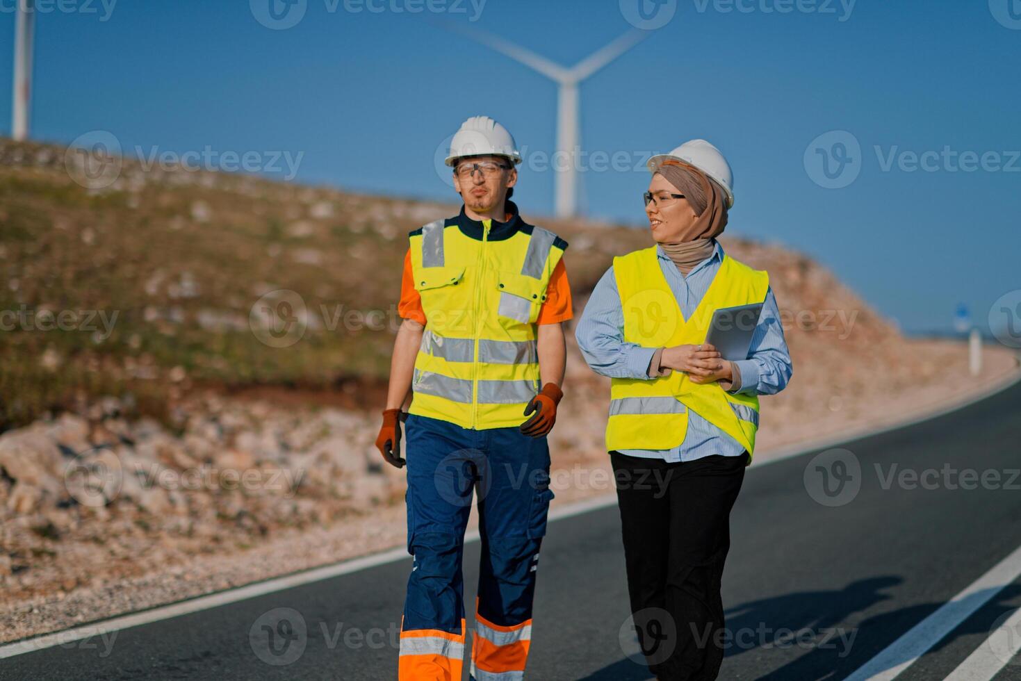 A team of engineers and workers oversees a wind turbine project at a modern wind farm, working together to ensure the efficient generation of renewable energy photo