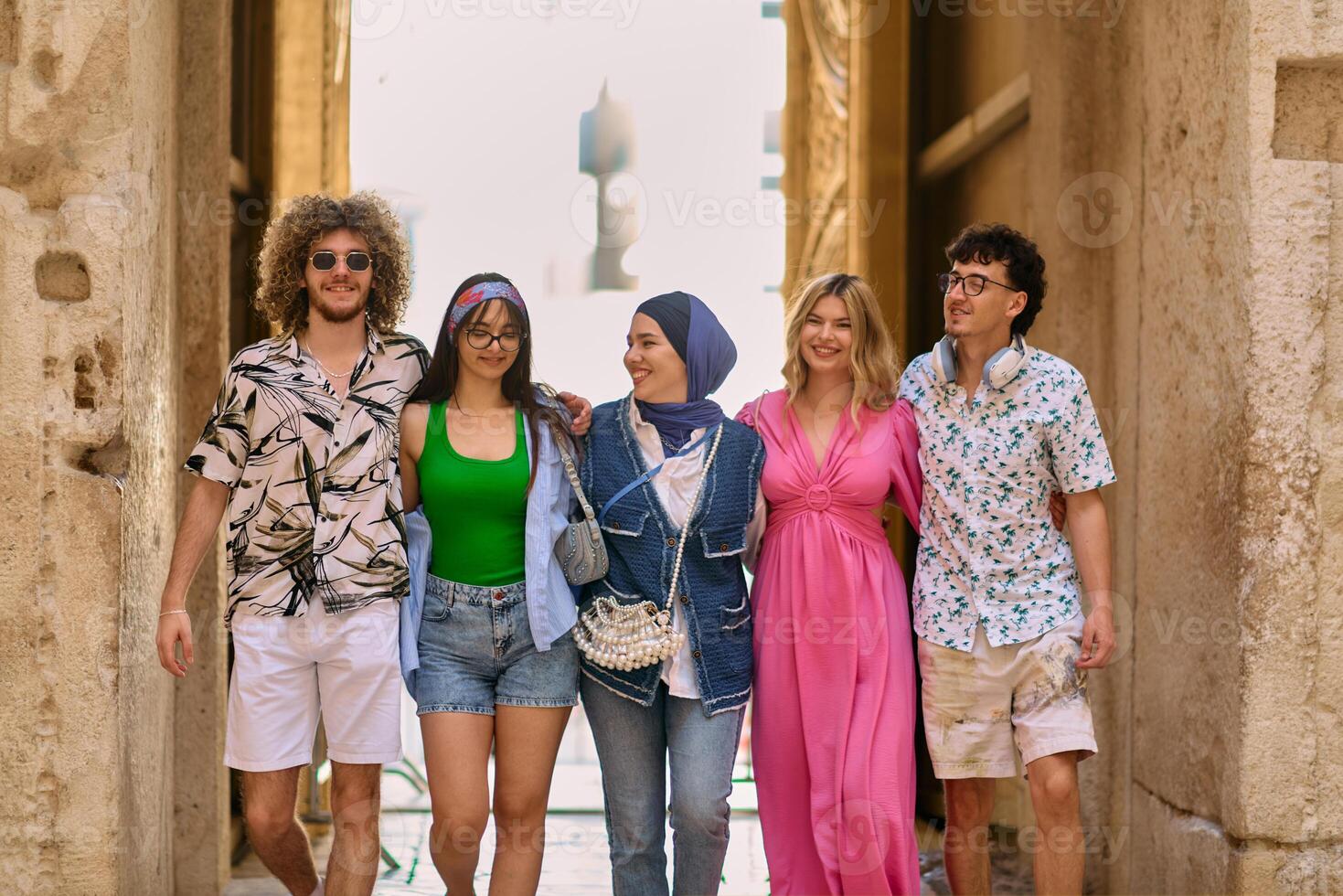 A diverse group of tourists, dressed in summer attire, strolls through the tourist city with wide smiles, enjoying their sightseeing adventure photo