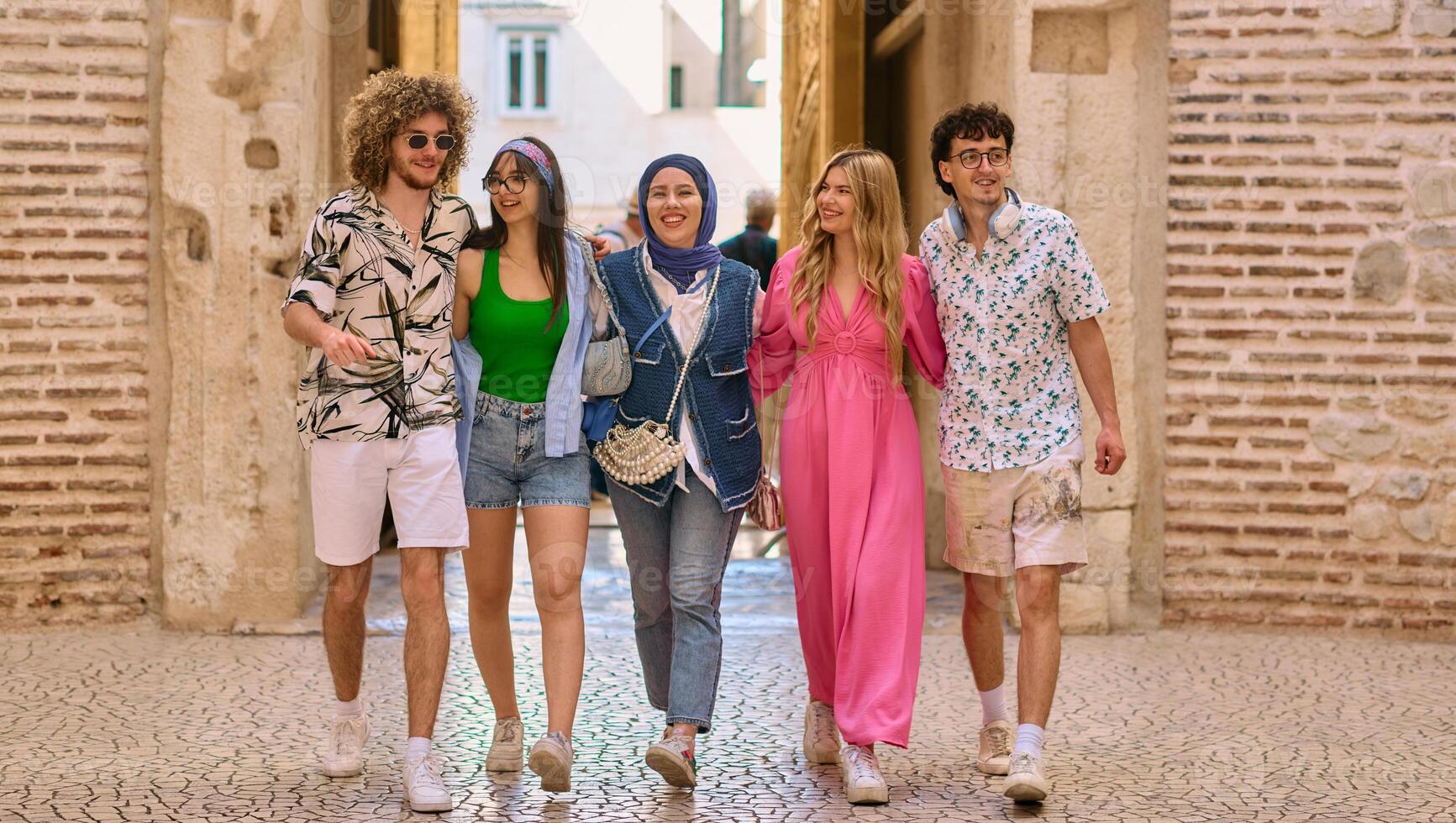 A diverse group of tourists, dressed in summer attire, strolls through the tourist city with wide smiles, enjoying their sightseeing adventure photo