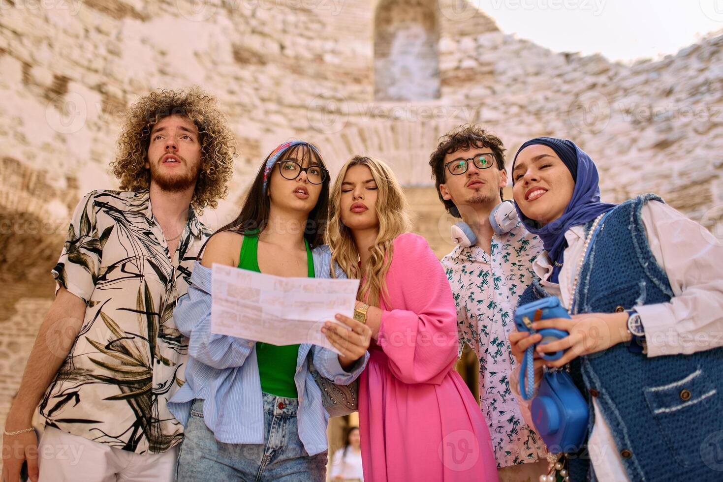Happy traveling friends tourists sightseeing with map in hand photo