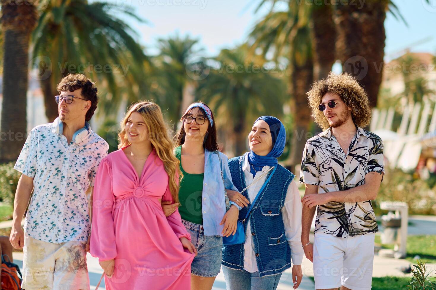 A diverse group of tourists, dressed in summer attire, strolls through the tourist city with wide smiles, enjoying their sightseeing adventure photo