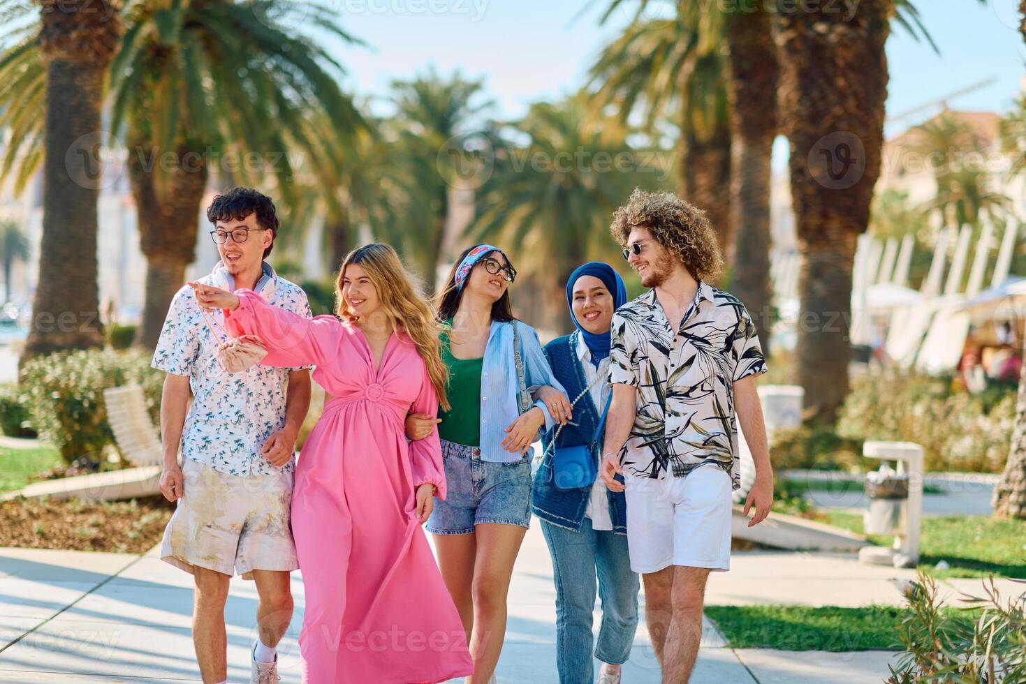 A diverse group of tourists, dressed in summer attire, strolls through the tourist city with wide smiles, enjoying their sightseeing adventure photo