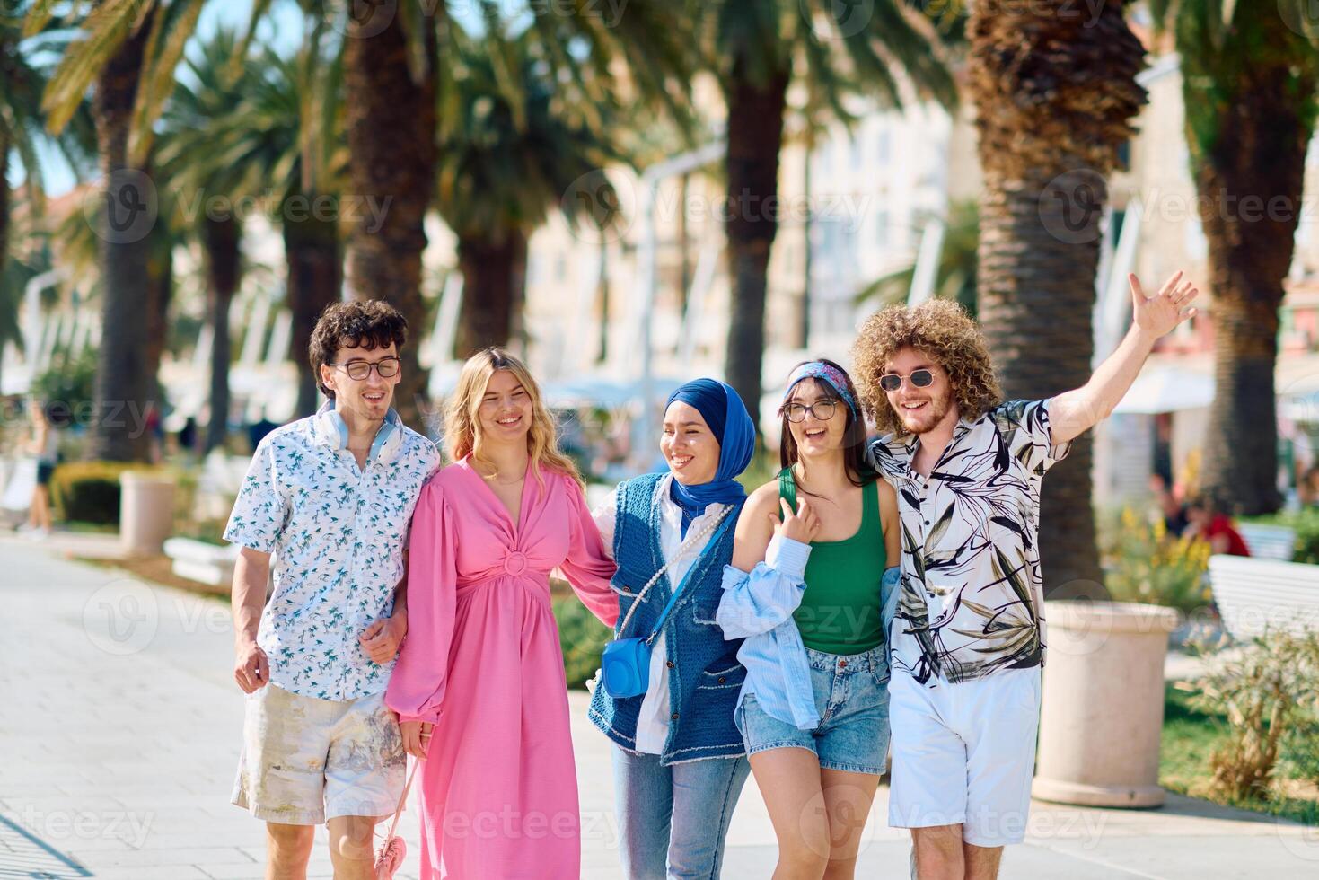A diverse group of tourists, dressed in summer attire, strolls through the tourist city with wide smiles, enjoying their sightseeing adventure photo