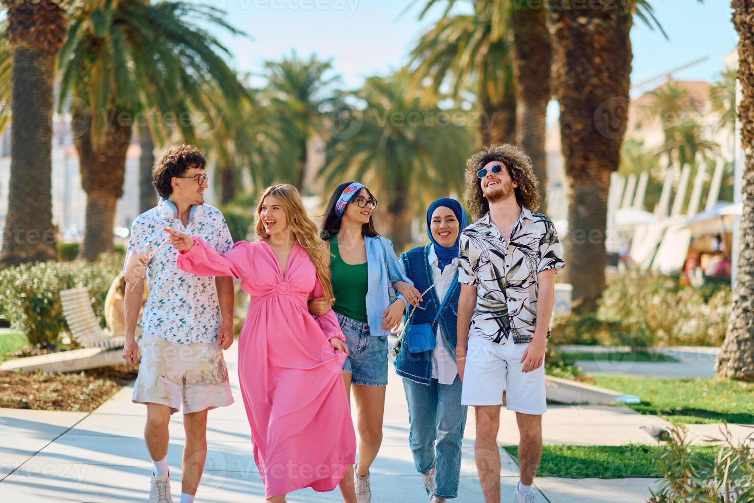 A diverse group of tourists, dressed in summer attire, strolls through the tourist city with wide smiles, enjoying their sightseeing adventure photo
