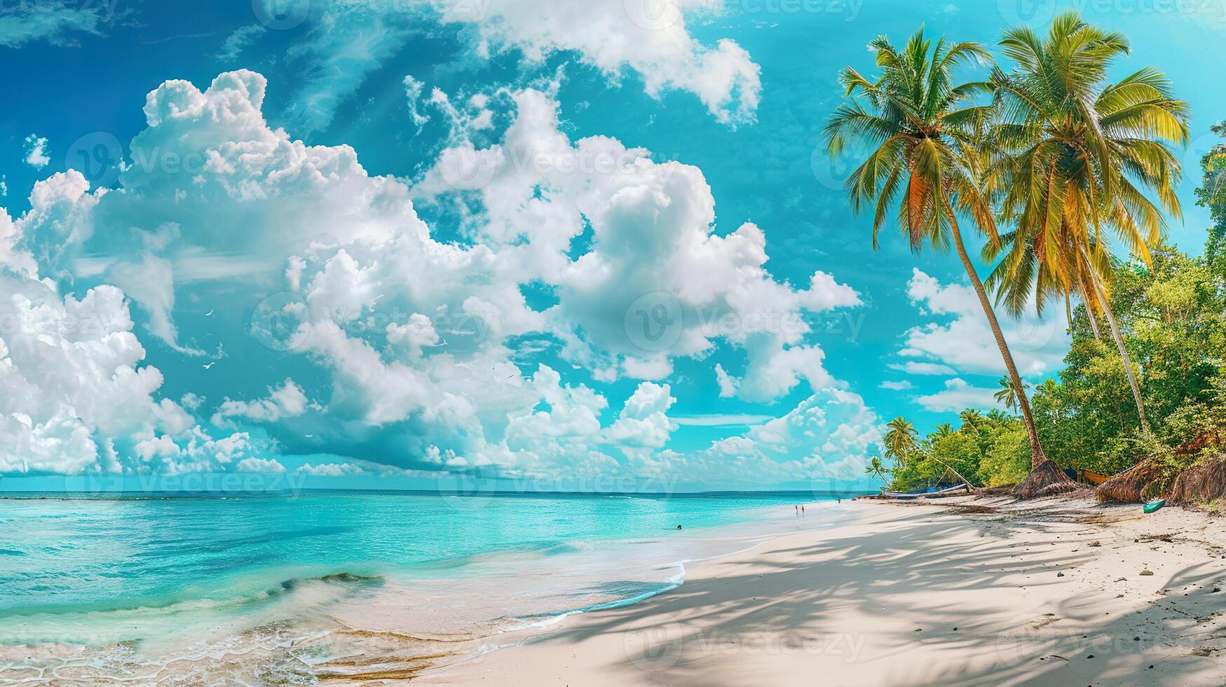 A beautiful beach with a clear blue ocean and a few clouds in the sky photo