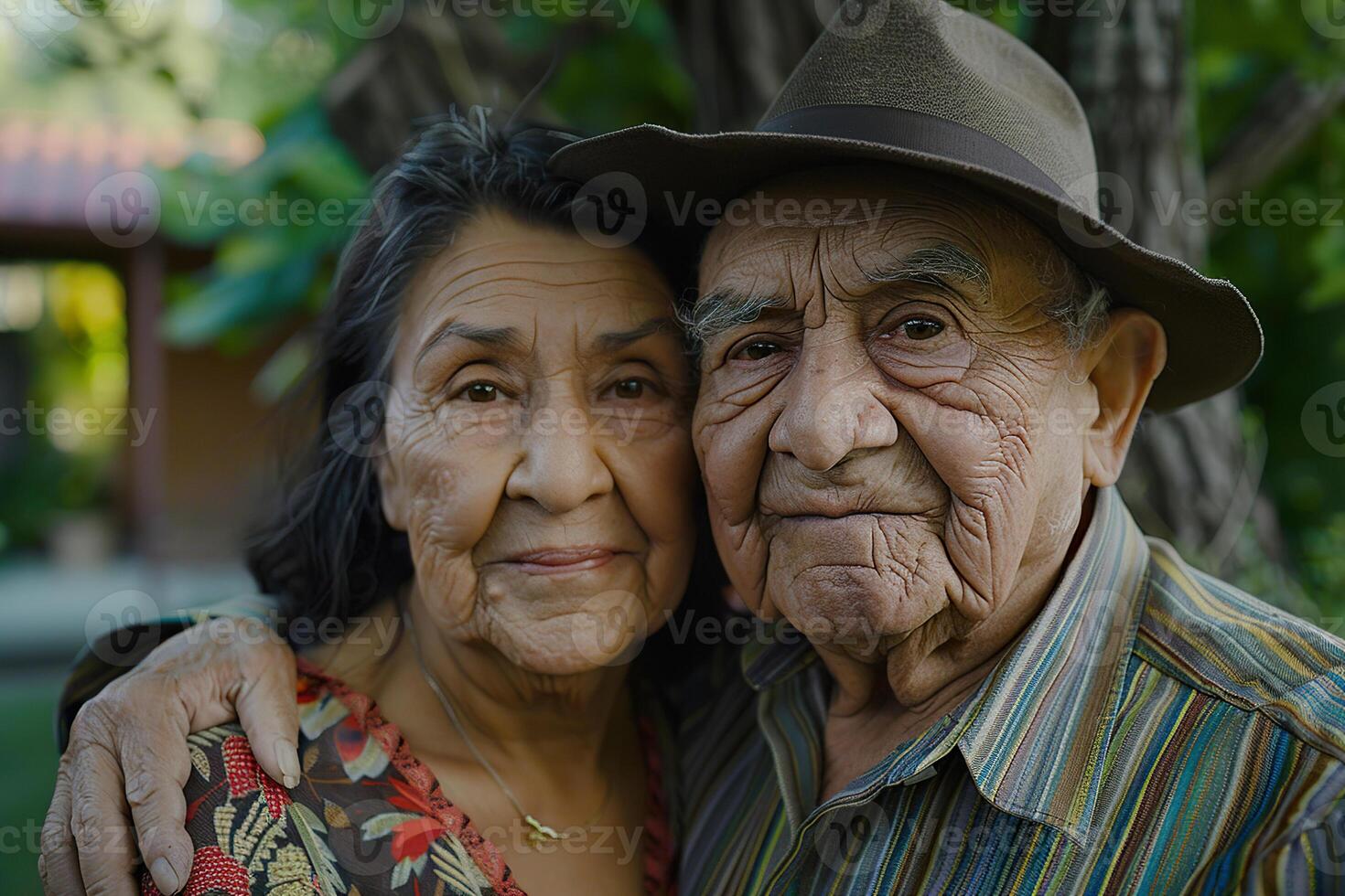 A man and woman are standing in a field, with the man wearing a straw hat photo