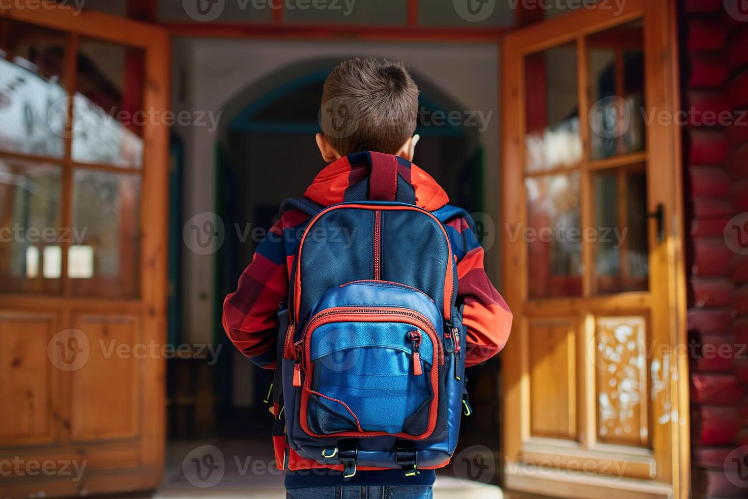 Back view of a boy kid entering the classroom with his backpack photo