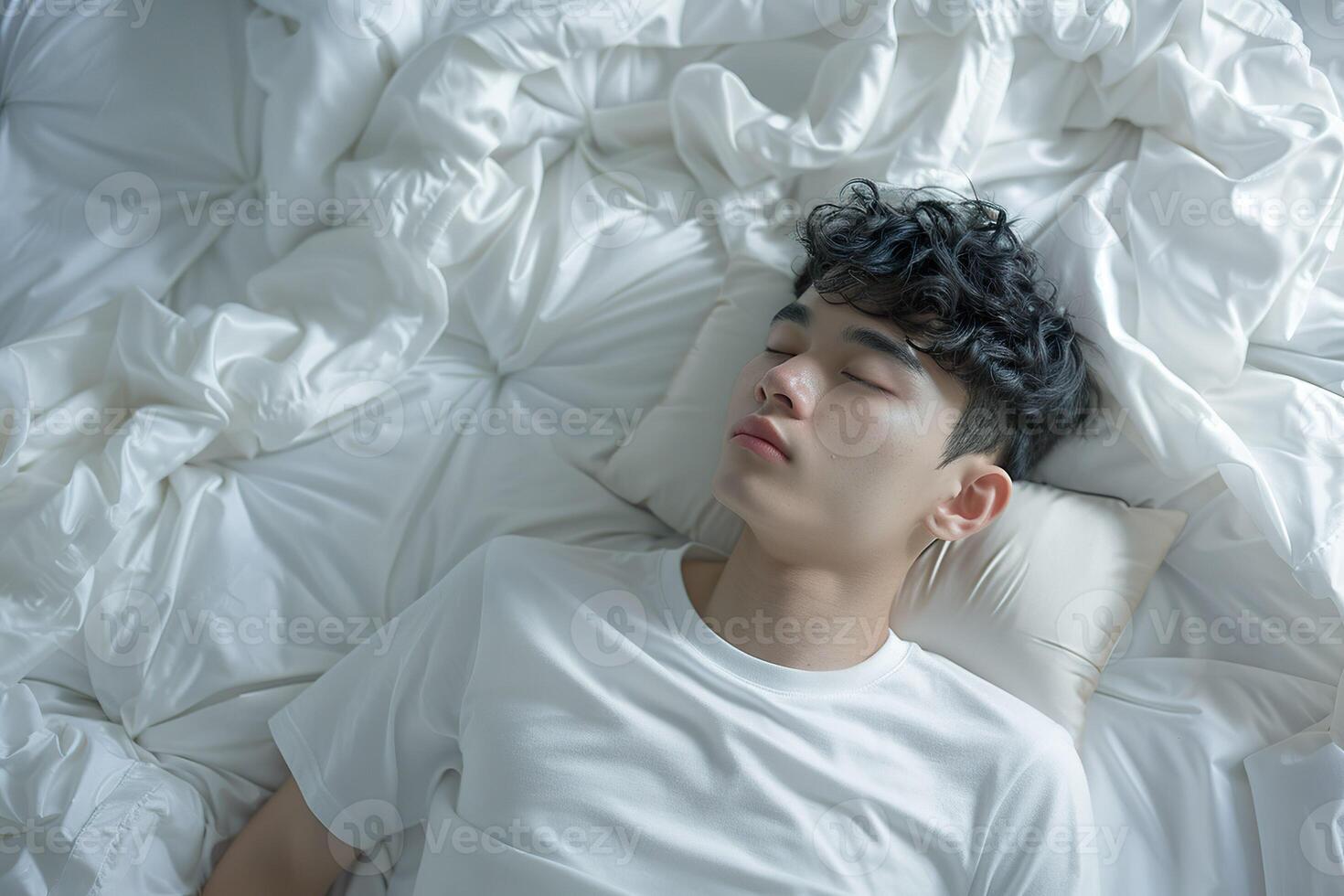 Asian man 20 yo in a white clothes laying down on white bed with white blanket, happily sleeping photo