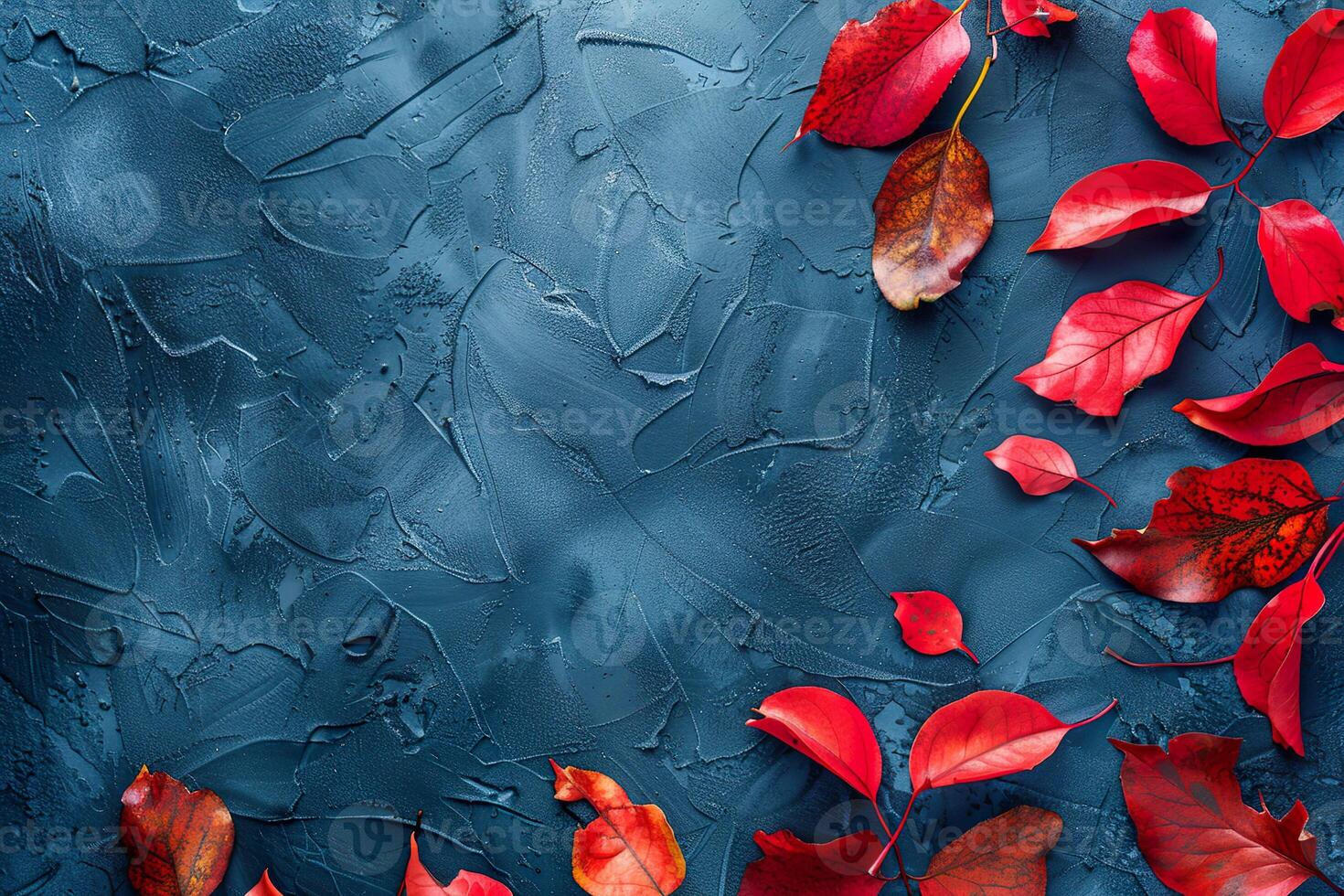 Autumn background with colored red leaves on blue slate background. Top view, copy space photo