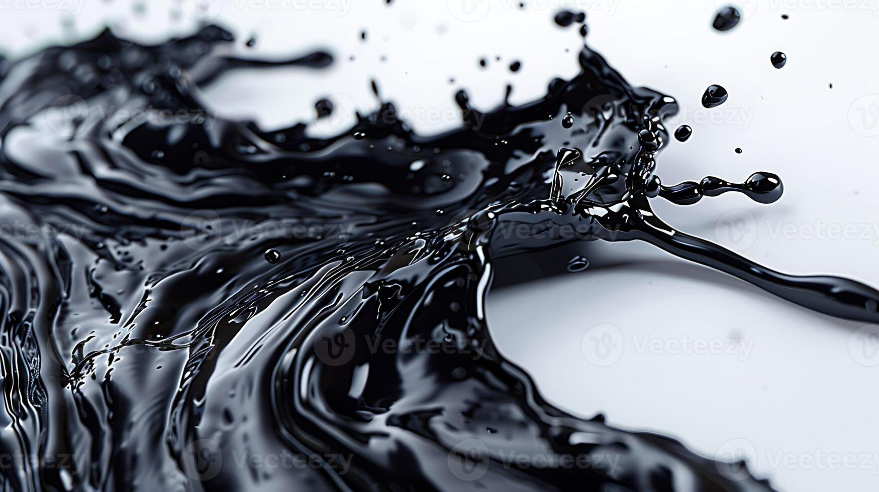 A close-up of black liquid splashing against a white background, creating a dynamic and abstract pattern photo