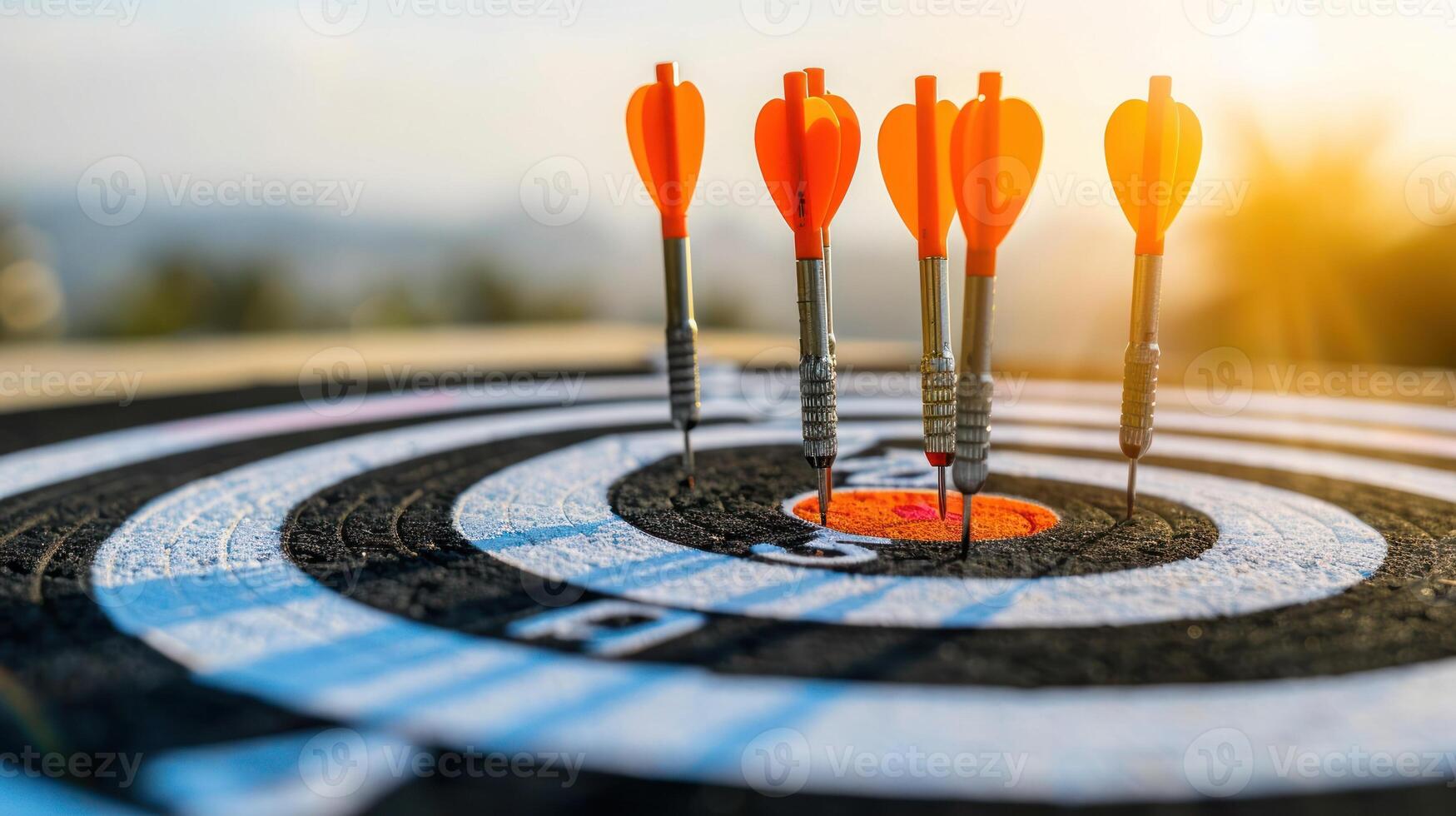 Multiple orange darts hit the bullseye of a dartboard photo