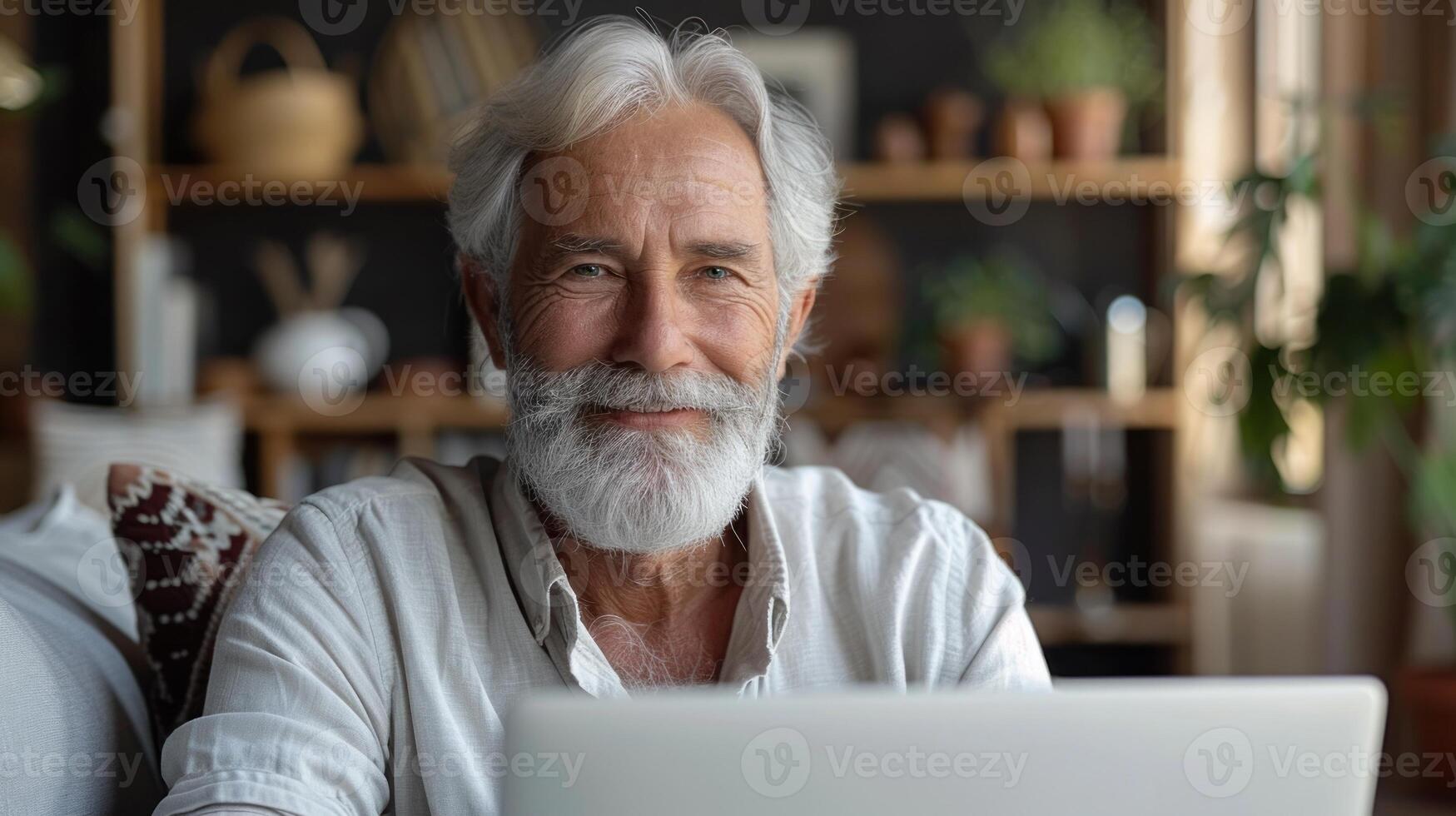Smiling man working on his laptop at home photo