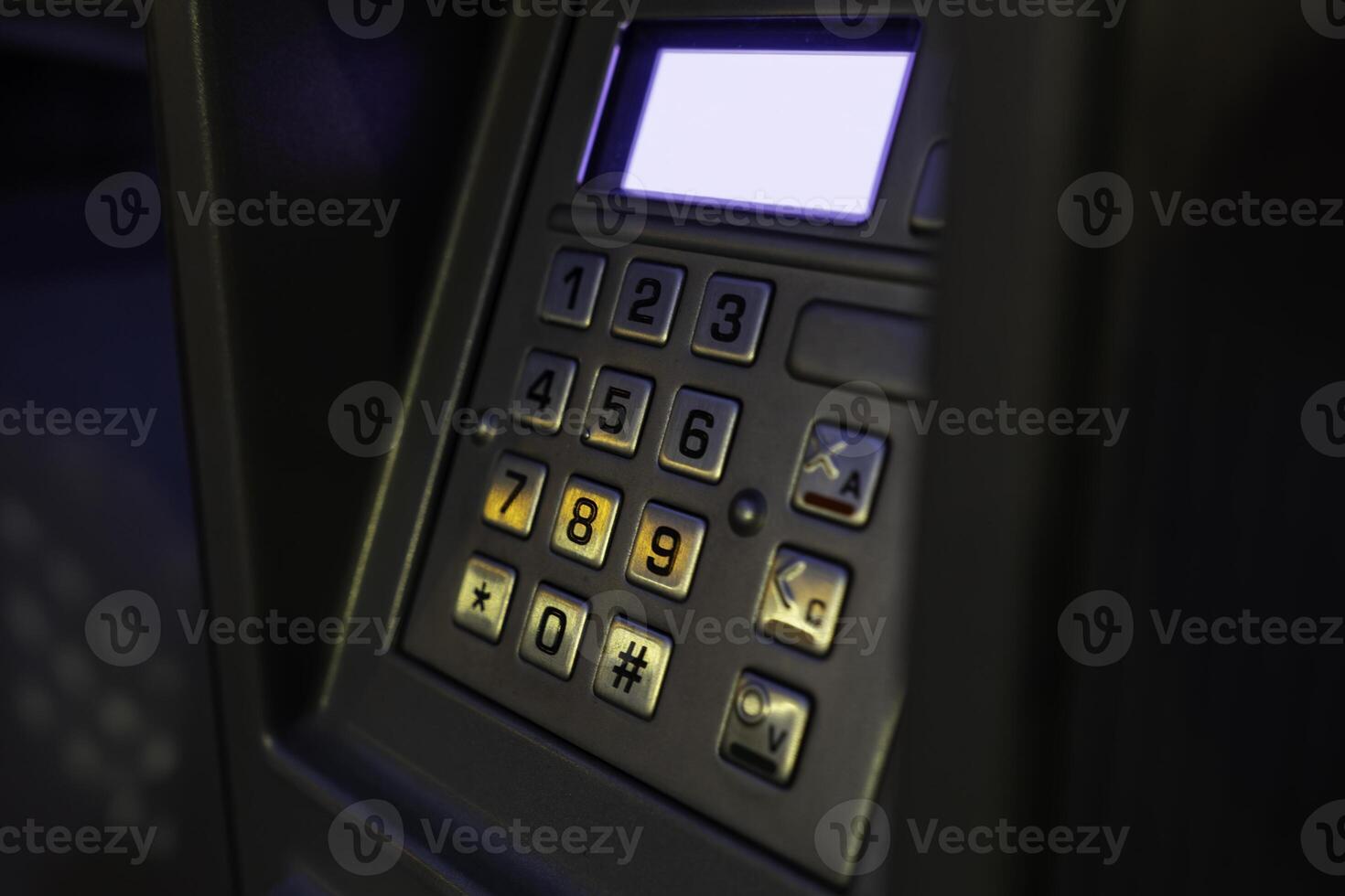 Close-up view of an ATM keypad with illuminated buttons in a low-light setting photo