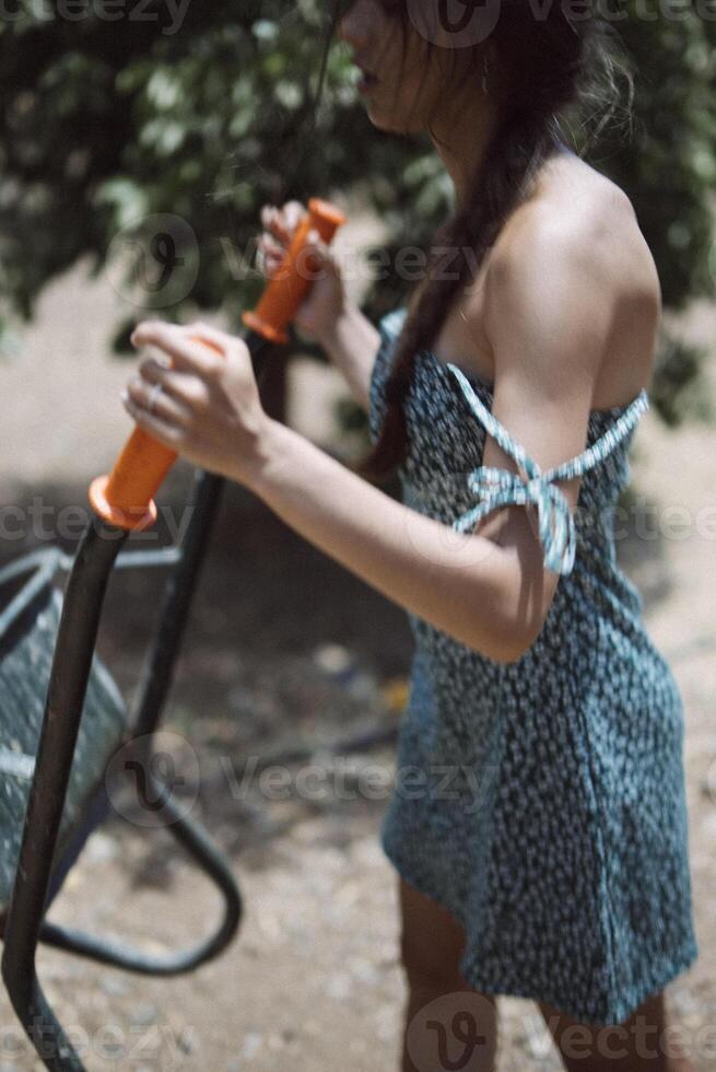 A young woman is engaging in outdoor exercise on a sunny day, using fitness equipment photo