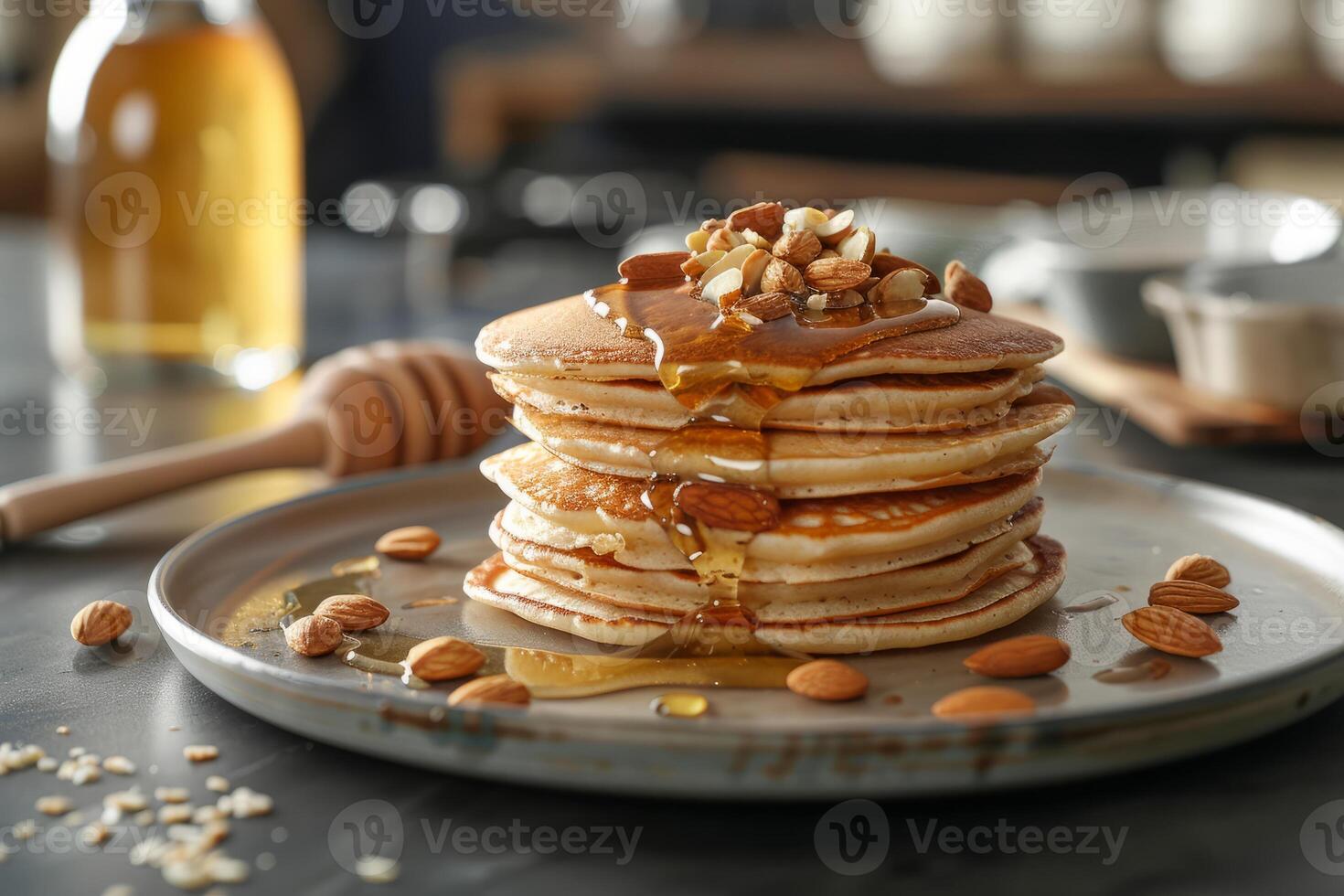 Stack of pancakes topped with honey and almonds on a plate photo