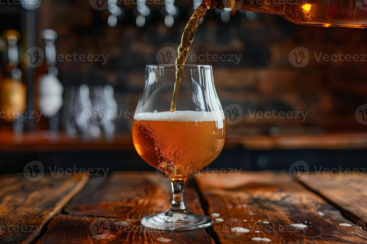 Pouring beer into a glass on a rustic wooden table photo
