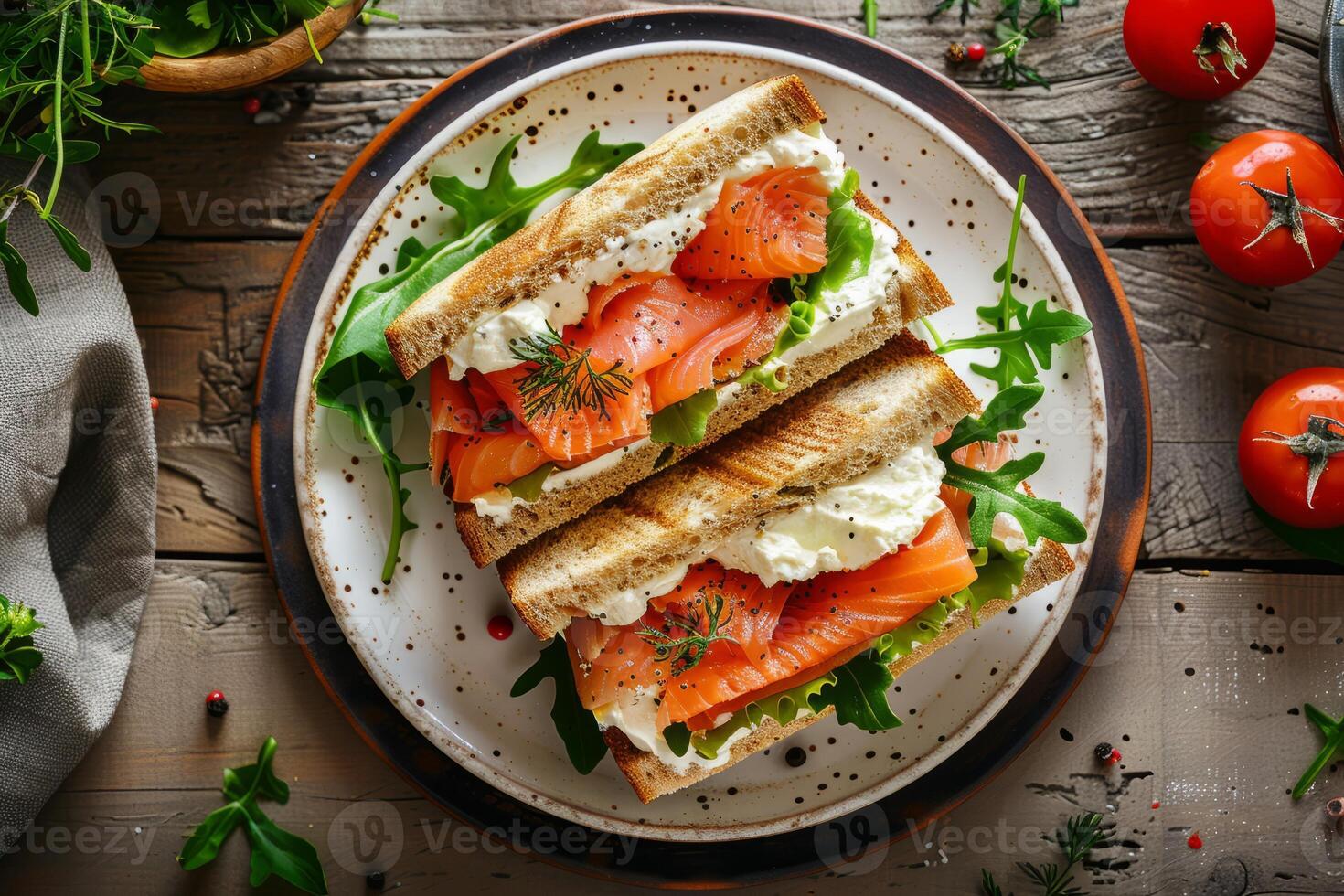 Salmon and cream cheese sandwich with fresh greens on a rustic plate photo