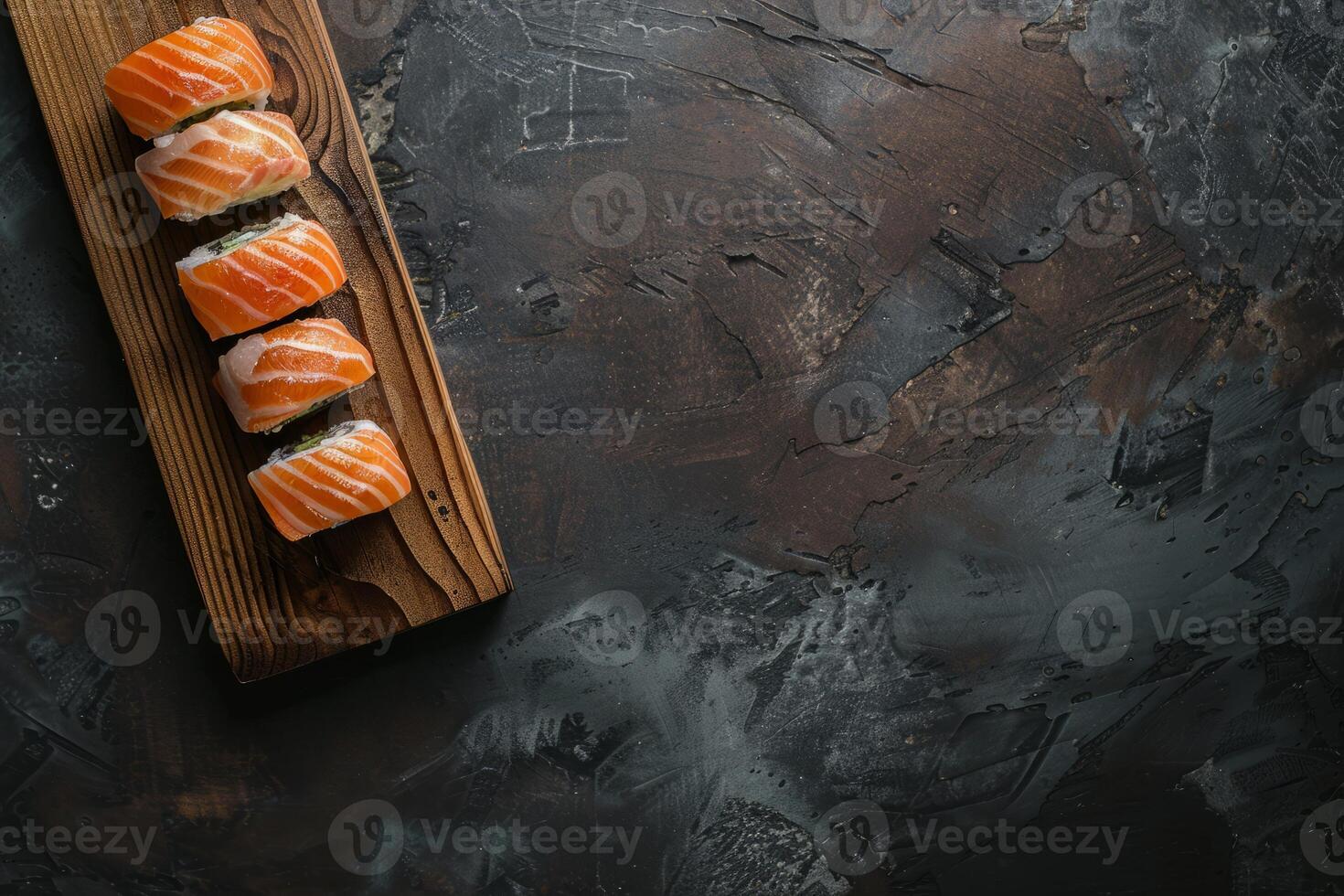 Sushi rolls with salmon on a wooden board against a dark textured background photo
