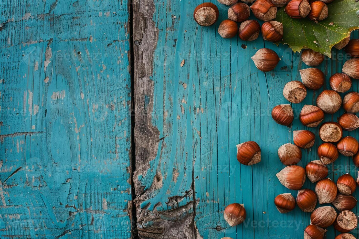 Hazelnuts scattered on a rustic blue wooden background photo