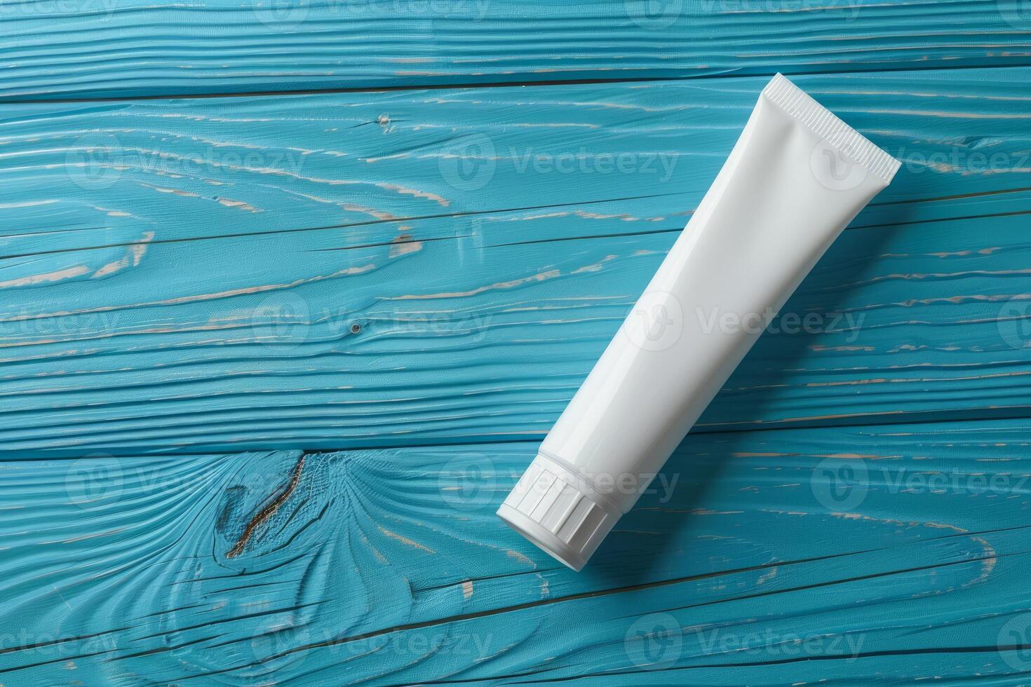 Toothpaste tube on a rustic blue wooden surface photo
