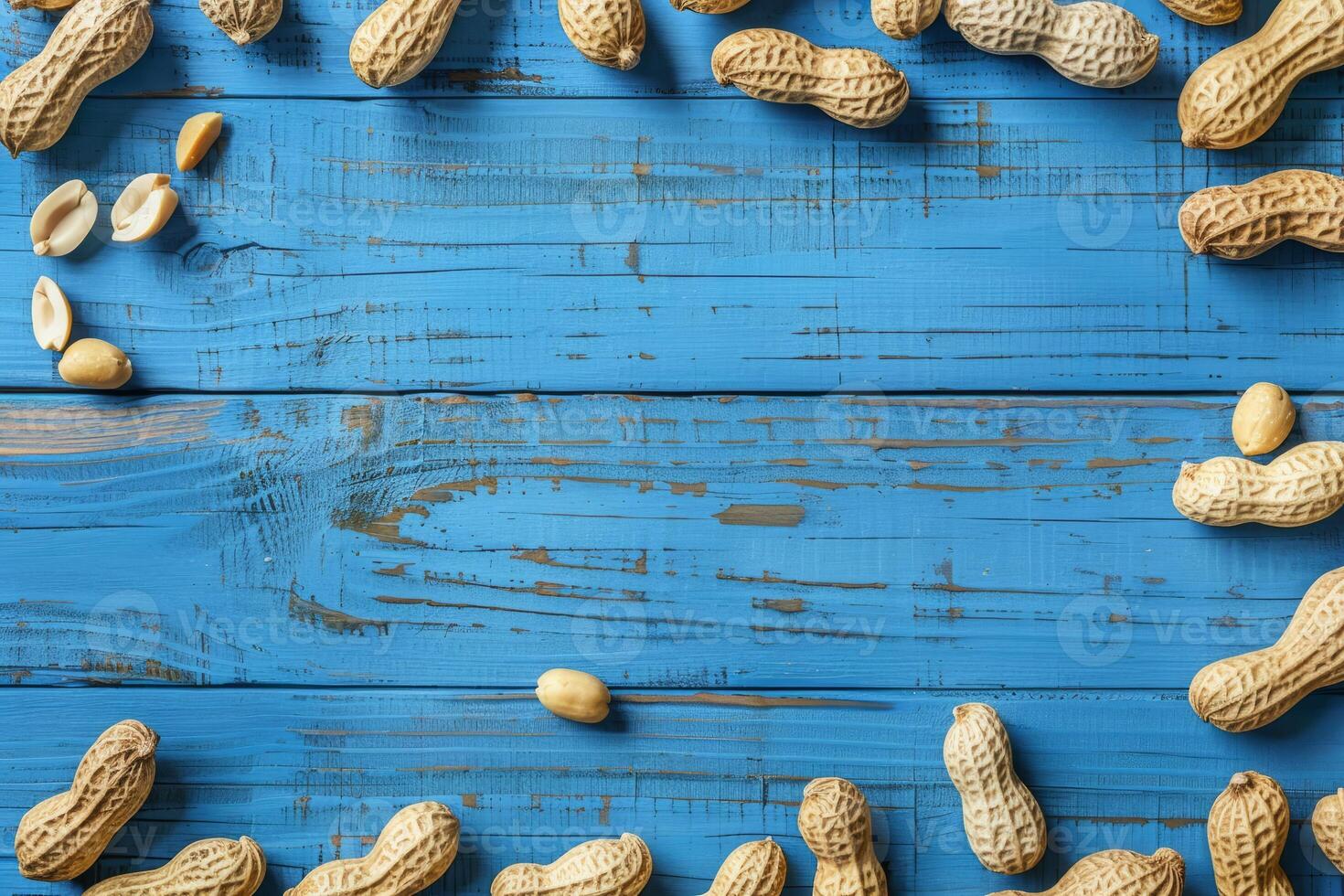 Peanuts in shells and shelled on a rustic blue wooden surface photo
