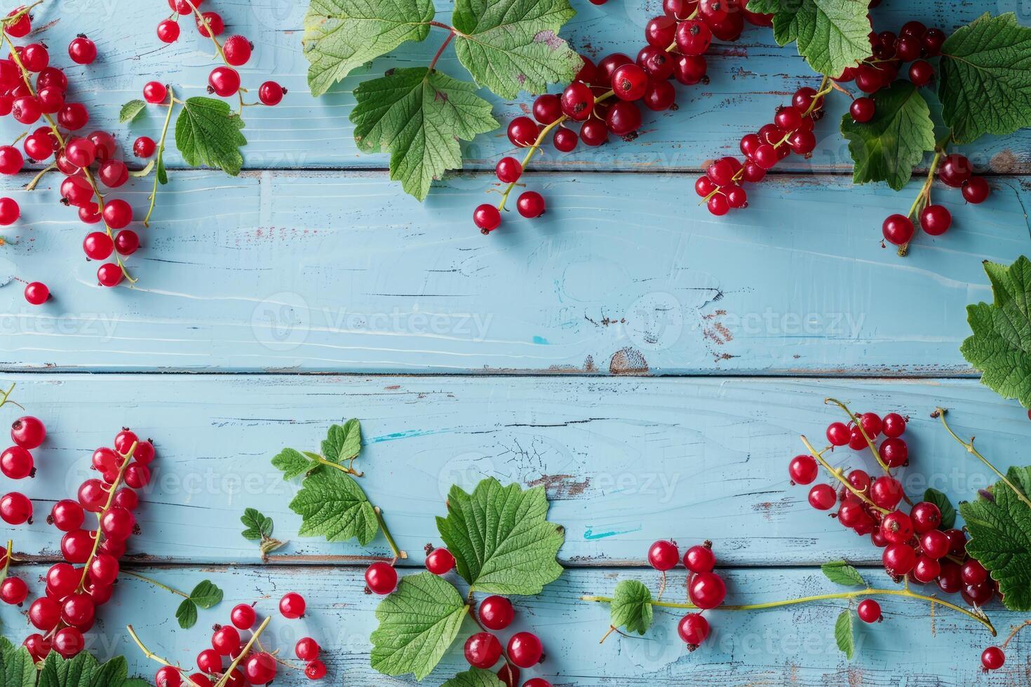 Beautifully arranged red currant branches and berries on a table, top view photo