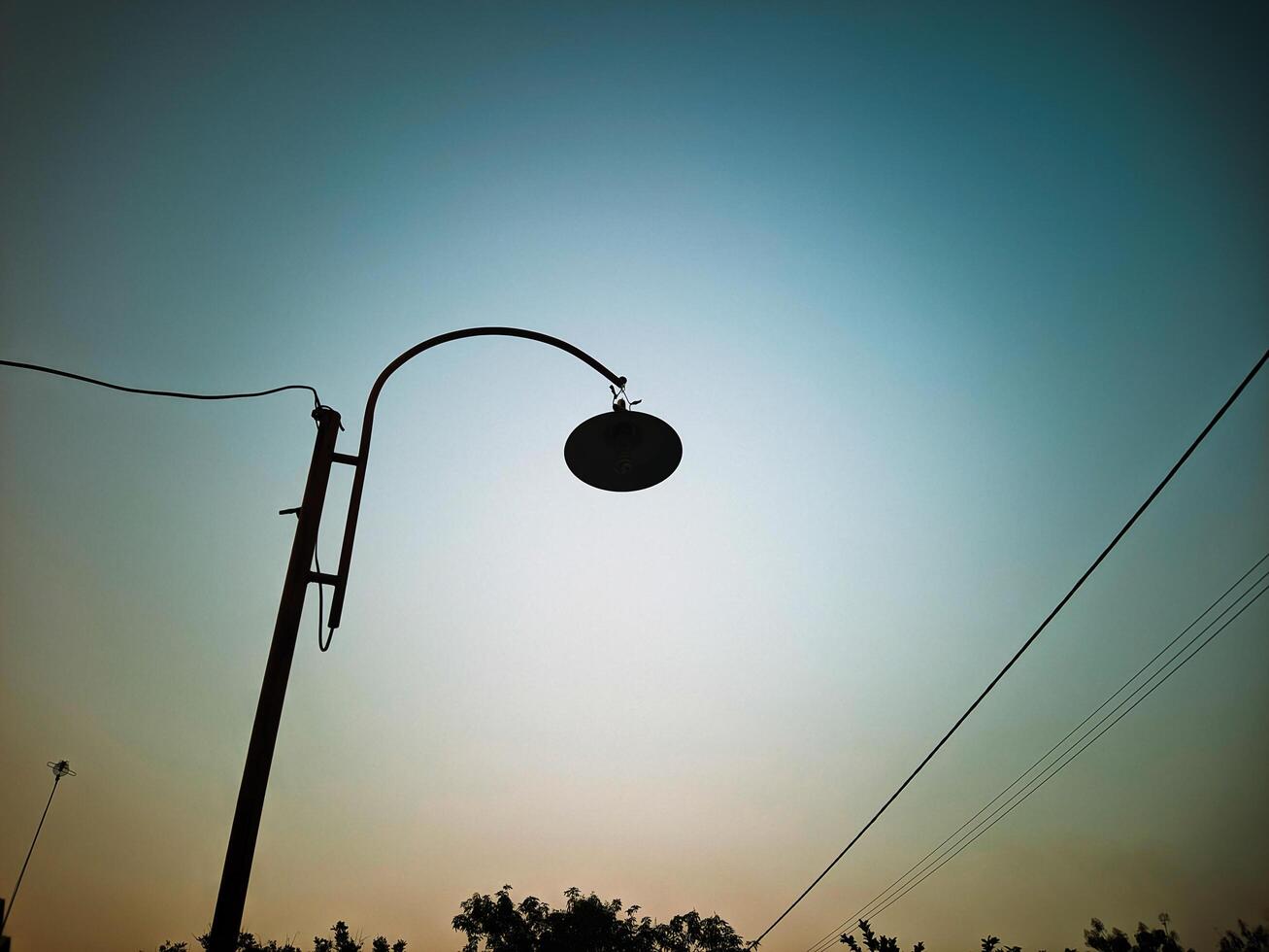 Peaceful Sunset Silhouette of a Street Lamp photo