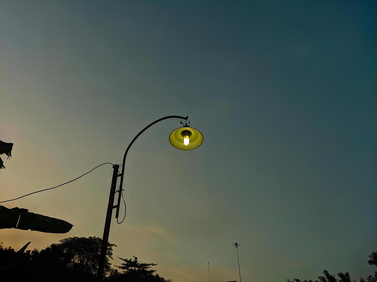 Peaceful Sunset Silhouette of a Street Lamp photo