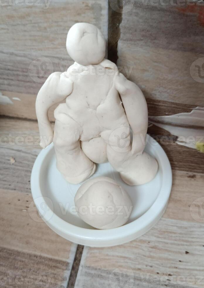 an abstract handmade playdoh in the shape of a human photo