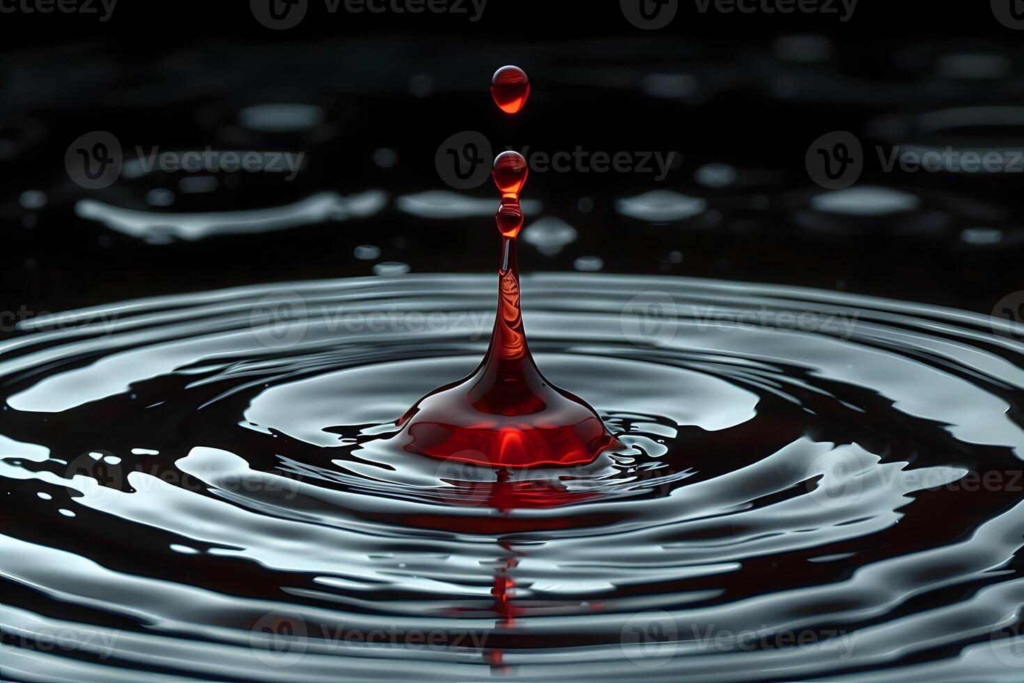 Red Liquid Droplet Splash Creating Ripples in Dark Water - Concept of Purity and Fluid Dynamics for Science and Art Projects photo