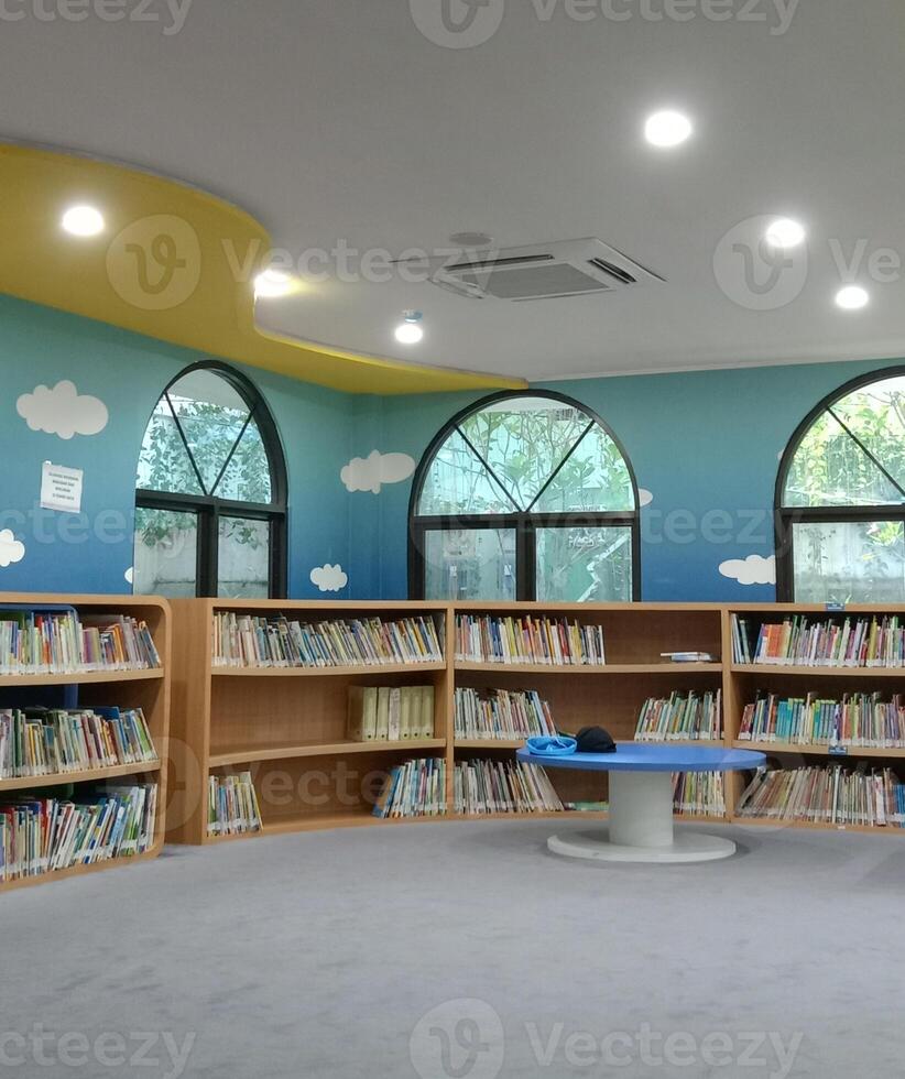 A neatly organized bookshelf nestled within the serene confines of the library photo