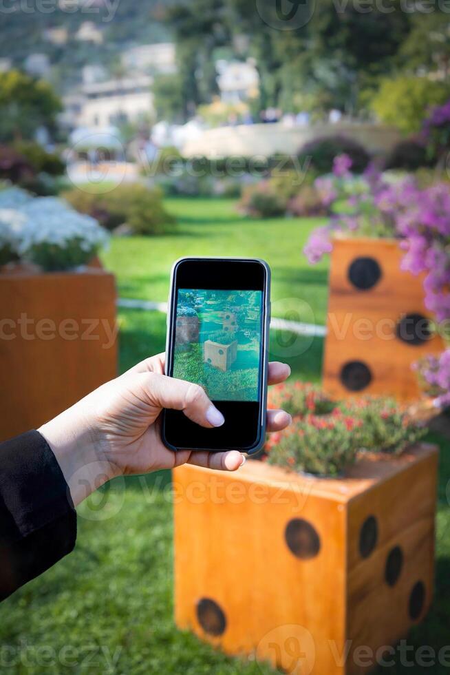 Close-up of female hands holding a mobile phone and taking a photo. Use of technology photo