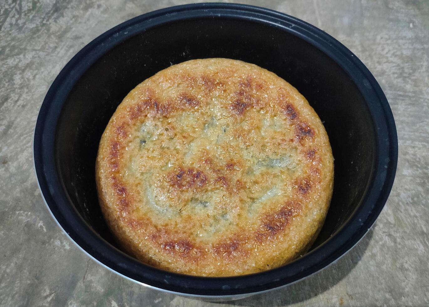 Photo of hardened rice, dry rice on magic com, the rice is dry and then hardened until it turns brownish. burnt rice, crusty rice