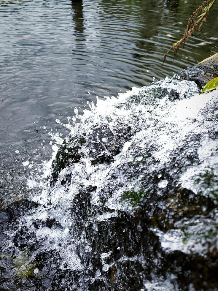 waterfall in the mountain splashing fresh water photo